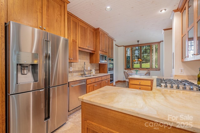 177 Yadkin Falls Rd, New London, NC 28127 - kitchen with appliances with stainless steel finishes, a peninsula, decorative backsplash, brown cabinets, and glass insert cabinets