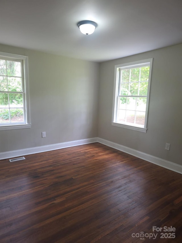 6820 Butterfly Ln, Kershaw, SC 29067 - empty room with plenty of natural light and dark wood finished floors