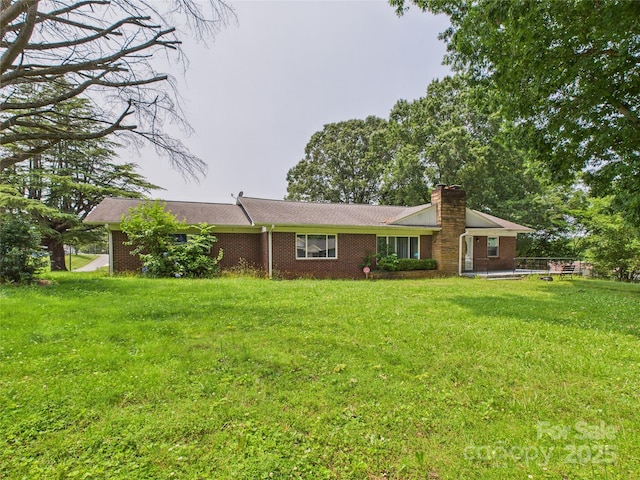 61 23rd St NW, Hickory, NC 28601 - view of front of home with a chimney, brick siding, and a front lawn