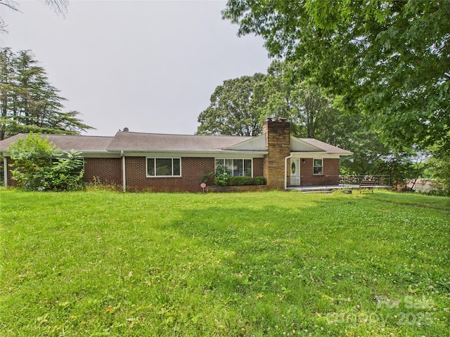 61 23rd St NW, Hickory, NC 28601 - view of front of home featuring a chimney, a front lawn, and brick siding