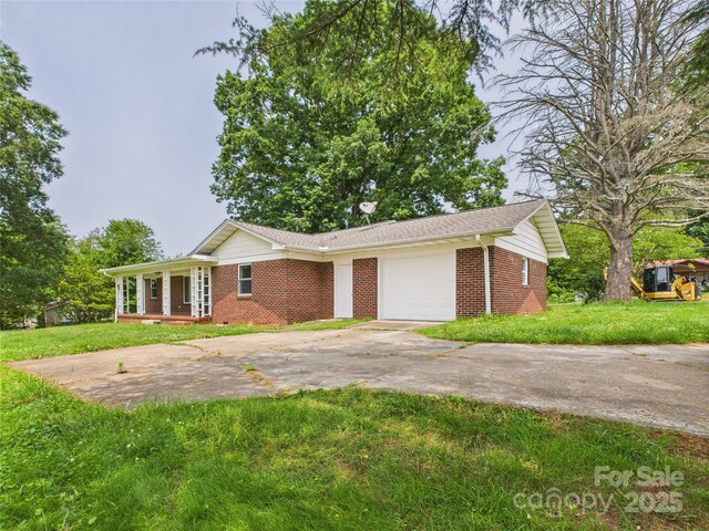 61 23rd St NW, Hickory, NC 28601 - single story home with brick siding, driveway, a garage, and a front lawn