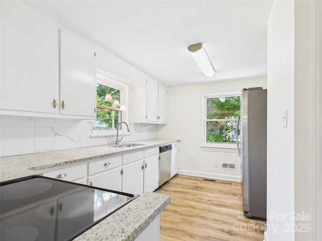 61 23rd St NW, Hickory, NC 28601 - kitchen featuring freestanding refrigerator, dishwasher, backsplash, white cabinets, and light wood finished floors