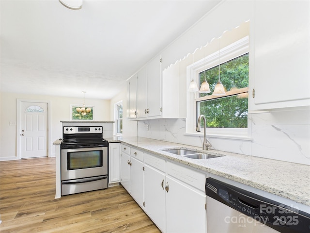 61 23rd St NW, Hickory, NC 28601 - kitchen featuring stainless steel appliances, white cabinetry, a chandelier, and decorative backsplash