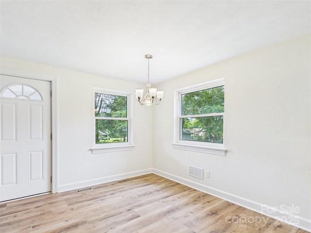 61 23rd St NW, Hickory, NC 28601 - unfurnished room featuring a chandelier and light wood finished floors