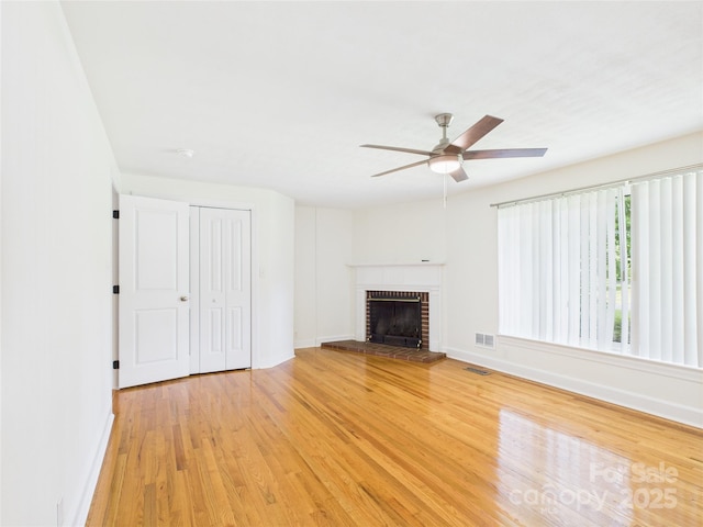 61 23rd St NW, Hickory, NC 28601 - unfurnished living room with ceiling fan, light wood-style flooring, and a fireplace