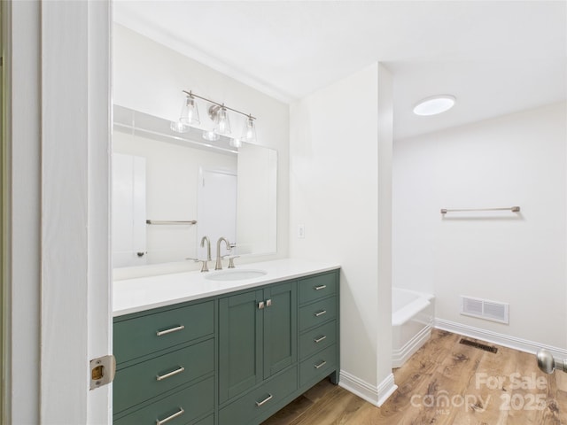 61 23rd St NW, Hickory, NC 28601 - full bathroom featuring vanity, wood finished floors, and a bath