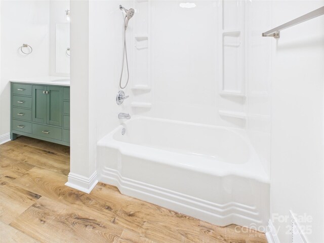 61 23rd St NW, Hickory, NC 28601 - full bath with wood finished floors, vanity, and shower / tub combination