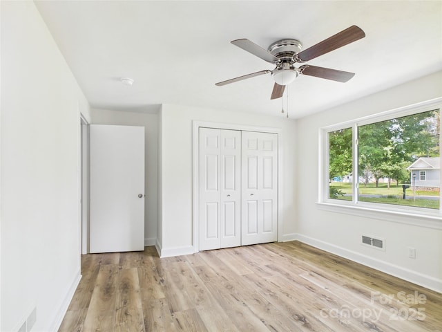 61 23rd St NW, Hickory, NC 28601 - unfurnished bedroom with a closet, light wood finished floors, and ceiling fan