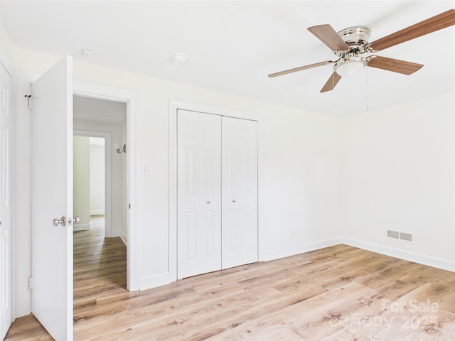 61 23rd St NW, Hickory, NC 28601 - unfurnished bedroom featuring light wood-type flooring, a closet, and a ceiling fan