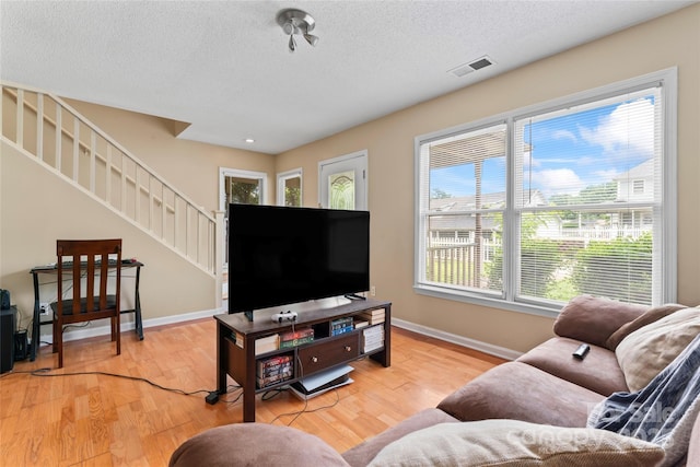1609 Begonia Way, Rock Hill, SC 29732 - living room with stairs, wood finished floors, and a textured ceiling