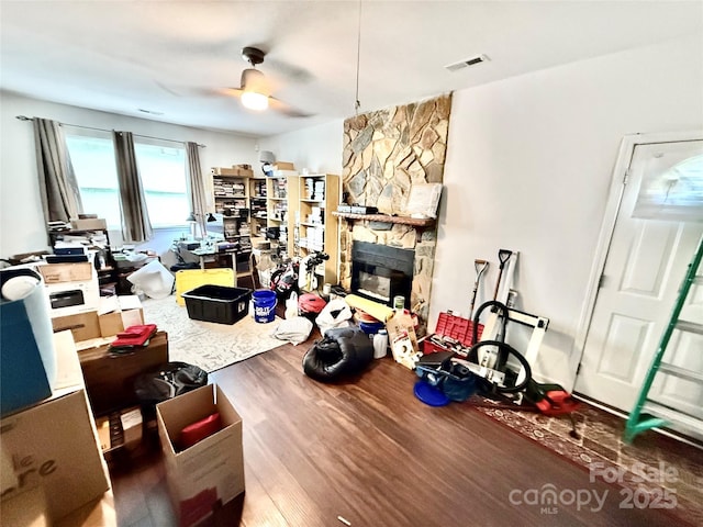 6007 Crosswood Ct, Charlotte, NC 28215 - living area with wood finished floors, ceiling fan, and a stone fireplace