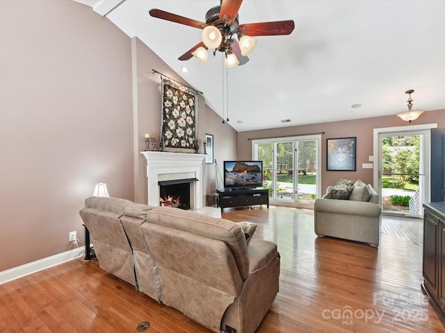 7139 Powder Mill Pl, Charlotte, NC 28277 - living area with lofted ceiling, a lit fireplace, a ceiling fan, light wood finished floors, and healthy amount of natural light