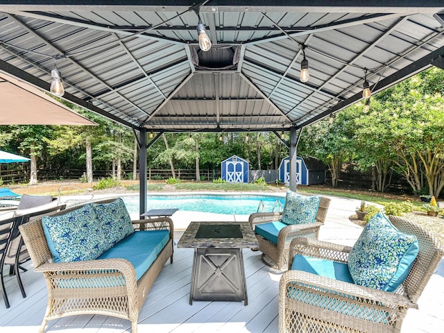 7139 Powder Mill Pl, Charlotte, NC 28277 - deck featuring a shed, an outdoor living space with a fire pit, an outdoor pool, and a gazebo