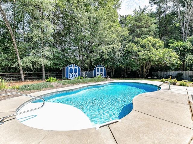 7139 Powder Mill Pl, Charlotte, NC 28277 - view of pool featuring a storage unit, a fenced backyard, a patio, and view of scattered trees