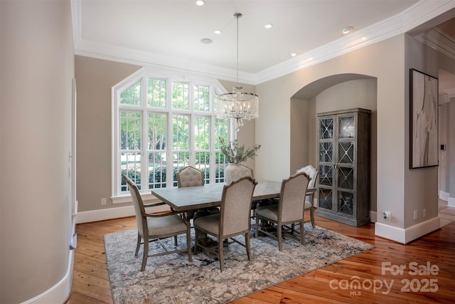 175 Rehoboth Ln, Mooresville, NC 28117 - dining space with arched walkways, ornamental molding, a chandelier, wood-type flooring, and recessed lighting