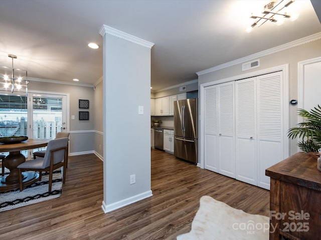 1708 Roxborough Rd Unit C, Charlotte, NC 28211 - kitchen featuring a chandelier, appliances with stainless steel finishes, dark wood-type flooring, ornamental molding, and recessed lighting