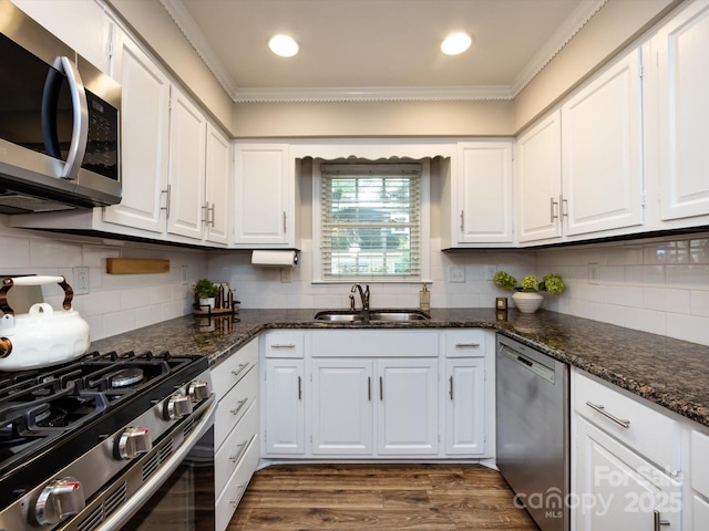 1708 Roxborough Rd Unit C, Charlotte, NC 28211 - kitchen featuring appliances with stainless steel finishes, ornamental molding, white cabinets, dark wood-type flooring, and decorative backsplash