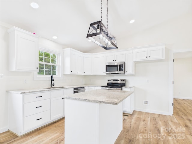 3016 Icard Rhodhiss Rd, Connelly Springs, NC 28612 - kitchen featuring stainless steel appliances, white cabinets, lofted ceiling, light wood finished floors, and light stone countertops