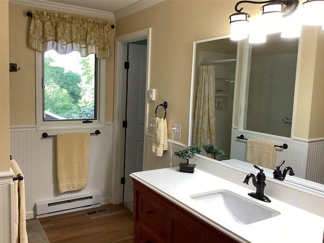31 Rhododendron Rd, Black Mountain, NC 28711 - bathroom featuring a baseboard heating unit, vanity, crown molding, a wainscoted wall, and wood finished floors