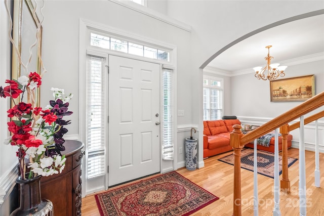 1069 Westlake Dr, Kannapolis, NC 28081 - entryway featuring arched walkways, a chandelier, crown molding, wainscoting, and light wood-type flooring