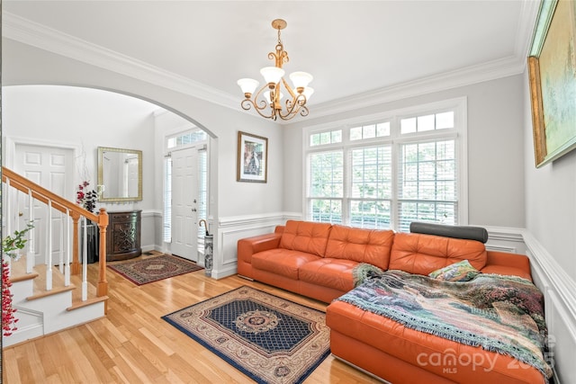 1069 Westlake Dr, Kannapolis, NC 28081 - living room with arched walkways, ornamental molding, a chandelier, stairs, and wainscoting
