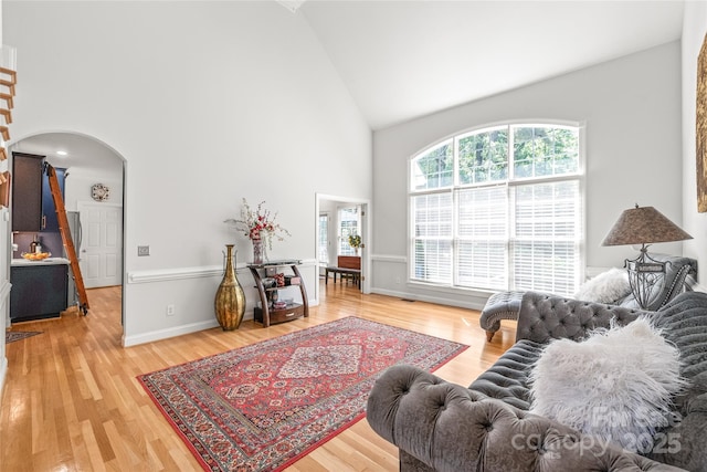 1069 Westlake Dr, Kannapolis, NC 28081 - living area with high vaulted ceiling, arched walkways, and light wood-style flooring