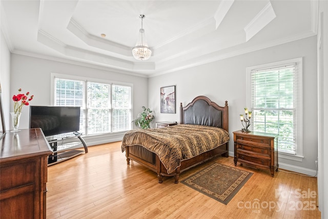1069 Westlake Dr, Kannapolis, NC 28081 - bedroom featuring a chandelier, a tray ceiling, ornamental molding, light wood-style floors, and a desk