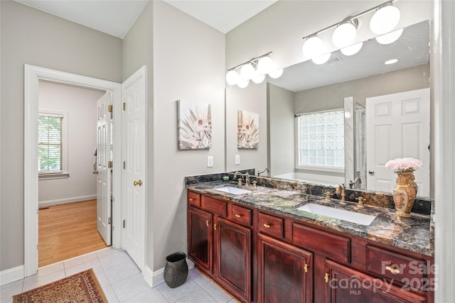1069 Westlake Dr, Kannapolis, NC 28081 - full bath with double vanity, tile patterned floors, and an enclosed shower