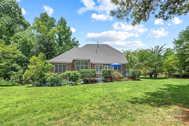 1069 Westlake Dr, Kannapolis, NC 28081 - back of house featuring brick siding, a yard, a wooden deck, and roof with shingles