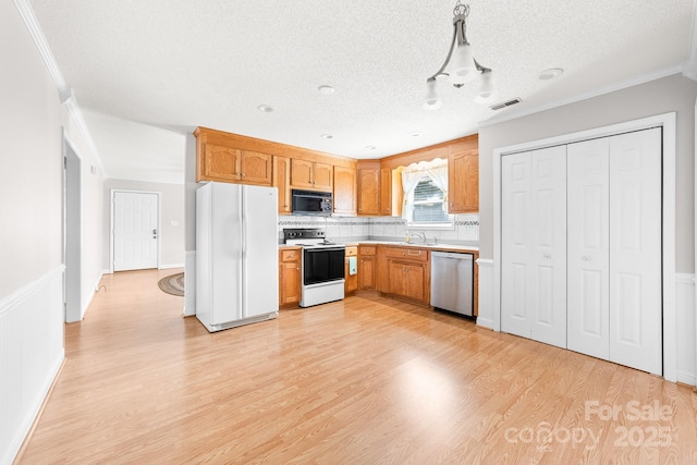 611 Church St, Belmont, NC 28012 - kitchen featuring white appliances, light wood-style floors, light countertops, ornamental molding, and tasteful backsplash