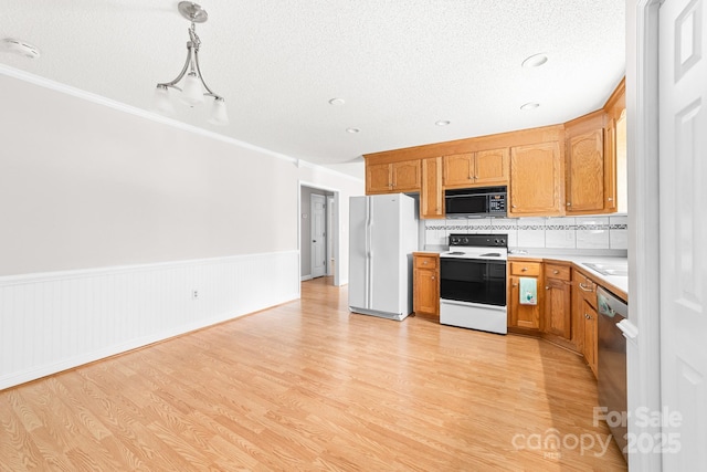 611 Church St, Belmont, NC 28012 - kitchen with white appliances, light countertops, light wood-type flooring, wainscoting, and a textured ceiling