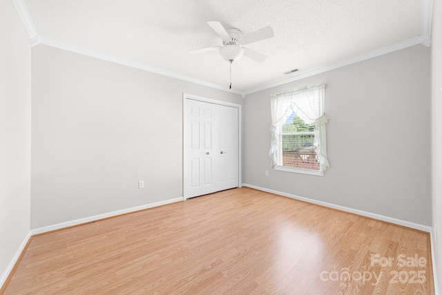 611 Church St, Belmont, NC 28012 - unfurnished bedroom featuring ornamental molding, wood finished floors, a closet, and ceiling fan