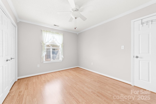 611 Church St, Belmont, NC 28012 - unfurnished bedroom with light wood-style flooring, crown molding, a closet, and a ceiling fan