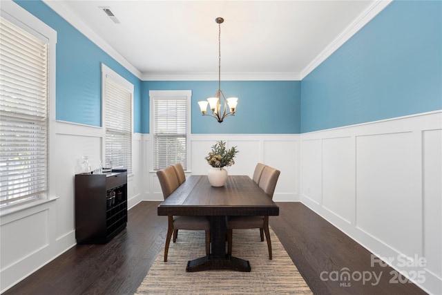 11806 Stirling Field Dr, Pineville, NC 28134 - dining room featuring a decorative wall, a chandelier, dark wood finished floors, wainscoting, and ornamental molding
