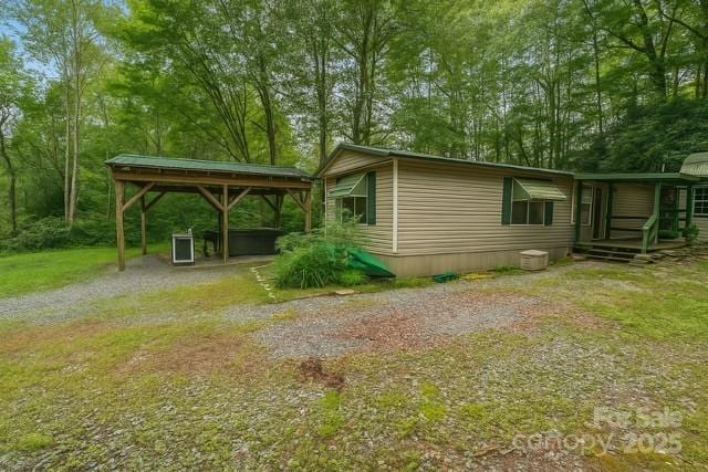 63 Apple Bee Rd, Brevard, NC 28712 - view of property exterior featuring driveway, a detached carport, and a lawn