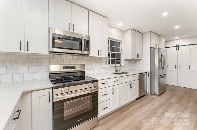 9410 Mountain Aire Cir, Charlotte, NC 28214 - kitchen featuring appliances with stainless steel finishes, light countertops, white cabinets, backsplash, and recessed lighting