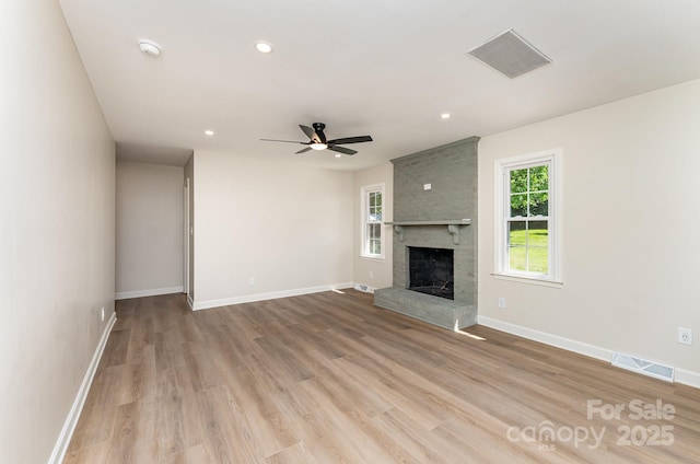 9410 Mountain Aire Cir, Charlotte, NC 28214 - unfurnished living room featuring a fireplace, ceiling fan, wood finished floors, and recessed lighting