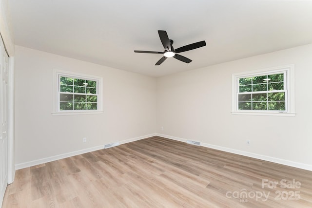 9410 Mountain Aire Cir, Charlotte, NC 28214 - empty room with healthy amount of natural light, light wood-type flooring, and a ceiling fan
