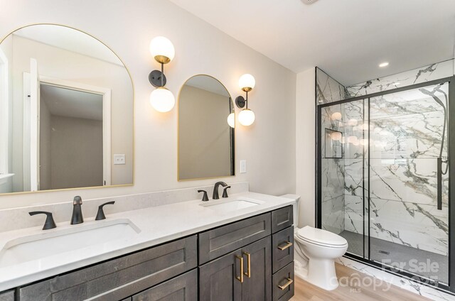 9410 Mountain Aire Cir, Charlotte, NC 28214 - bathroom featuring a marble finish shower, double vanity, and wood finished floors