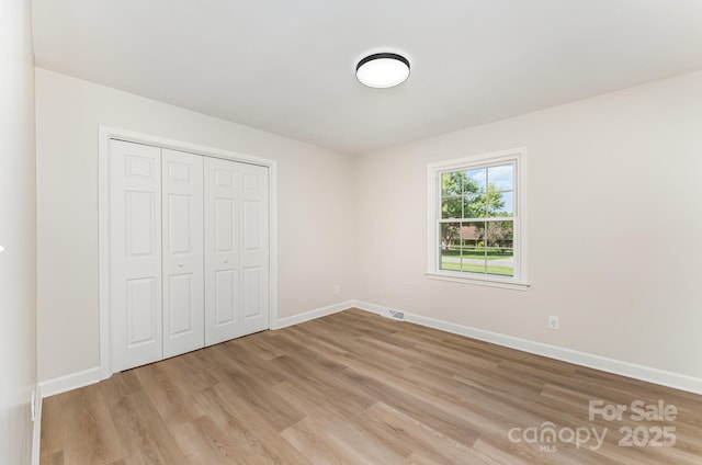 9410 Mountain Aire Cir, Charlotte, NC 28214 - unfurnished bedroom featuring light wood-type flooring and a closet