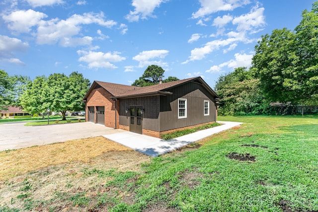9410 Mountain Aire Cir, Charlotte, NC 28214 - view of side of property with brick siding, concrete driveway, a yard, roof with shingles, and an attached garage