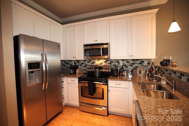 230 S Tryon St Unit 304, Charlotte, NC 28202 - kitchen featuring appliances with stainless steel finishes, crown molding, white cabinets, stone countertops, and decorative backsplash