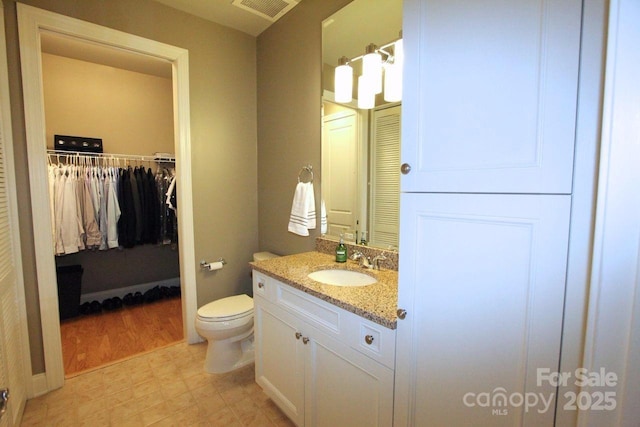 230 S Tryon St Unit 304, Charlotte, NC 28202 - bathroom with vanity and a walk in closet