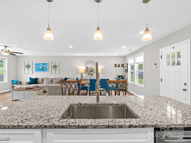 21 Brown Trout Trl, Candler, NC 28715 - kitchen with open floor plan, white cabinets, wood finished floors, hanging light fixtures, and light stone countertops