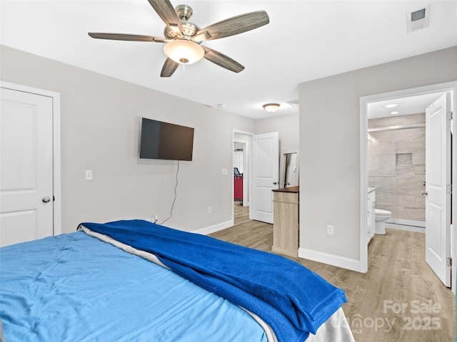 21 Brown Trout Trl, Candler, NC 28715 - bedroom featuring light wood-style flooring, ensuite bath, and ceiling fan
