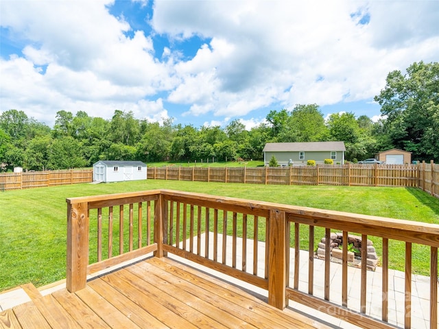 21 Brown Trout Trl, Candler, NC 28715 - wooden deck featuring a fenced backyard, a storage unit, and view of wooded area