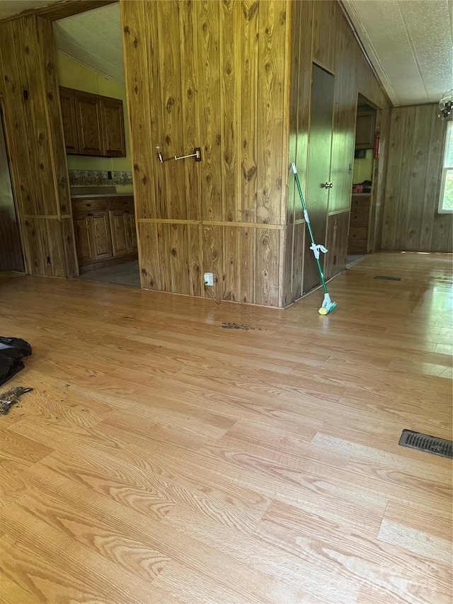 107 Round Pond Rd, Rutherfordton, NC 28139 - unfurnished room featuring light wood finished floors, vaulted ceiling, and wooden walls