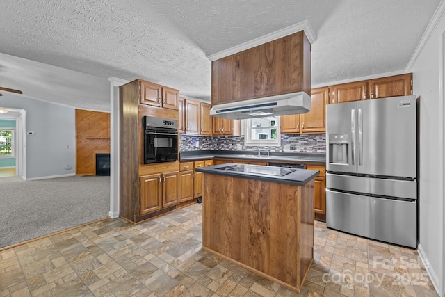 7011 S Providence Rd, Waxhaw, NC 28173 - kitchen featuring black appliances, under cabinet range hood, dark countertops, a center island, and decorative backsplash