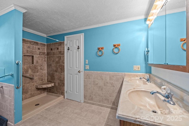7011 S Providence Rd, Waxhaw, NC 28173 - full bath featuring tile walls, double vanity, a tile shower, a wainscoted wall, and a textured ceiling