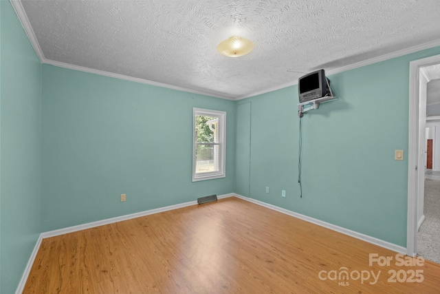 7011 S Providence Rd, Waxhaw, NC 28173 - unfurnished room featuring wood finished floors, crown molding, and a textured ceiling
